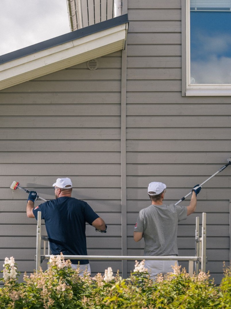Painters painting a wooden facade