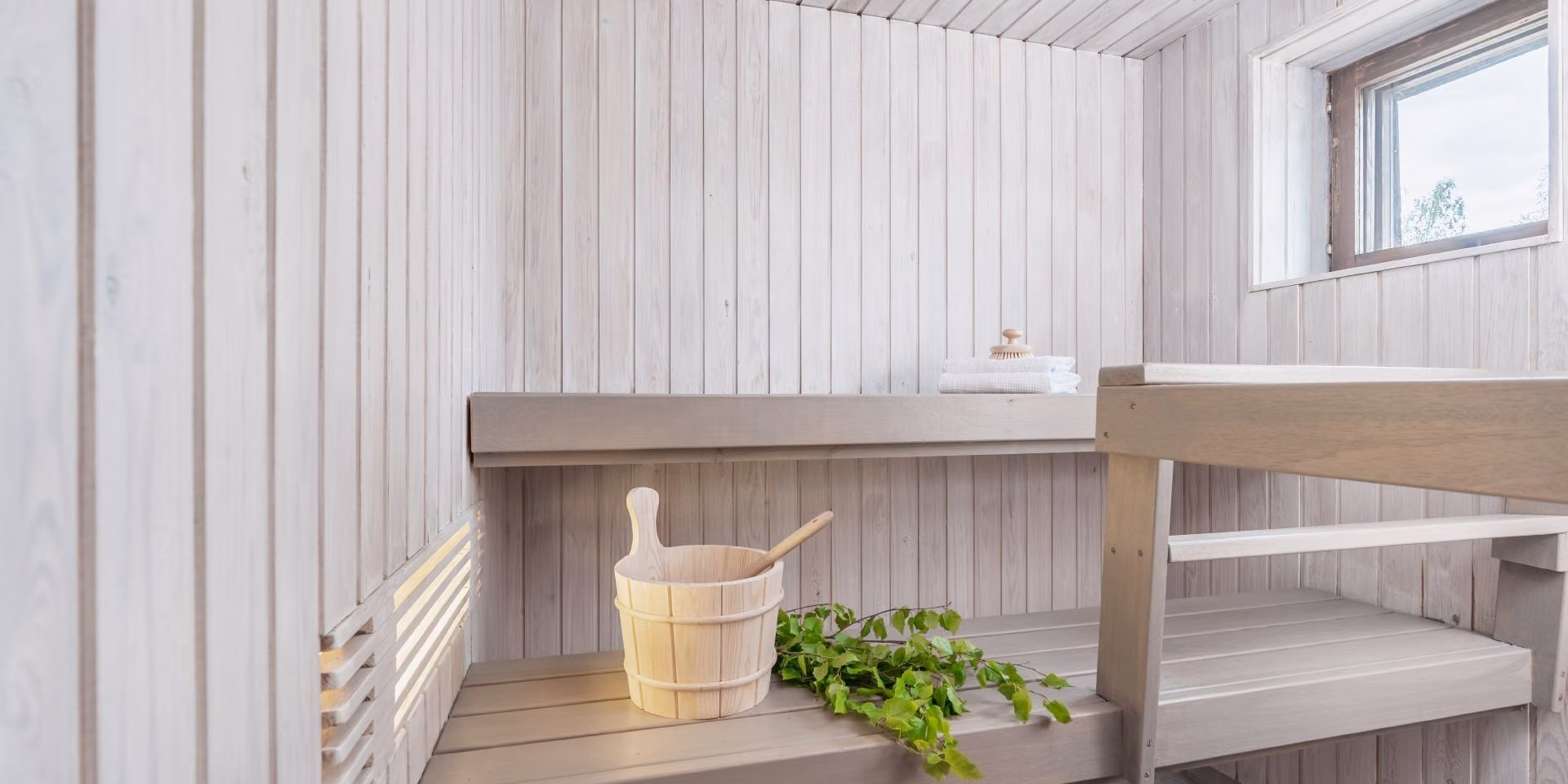 white colour sauna with light grey bench